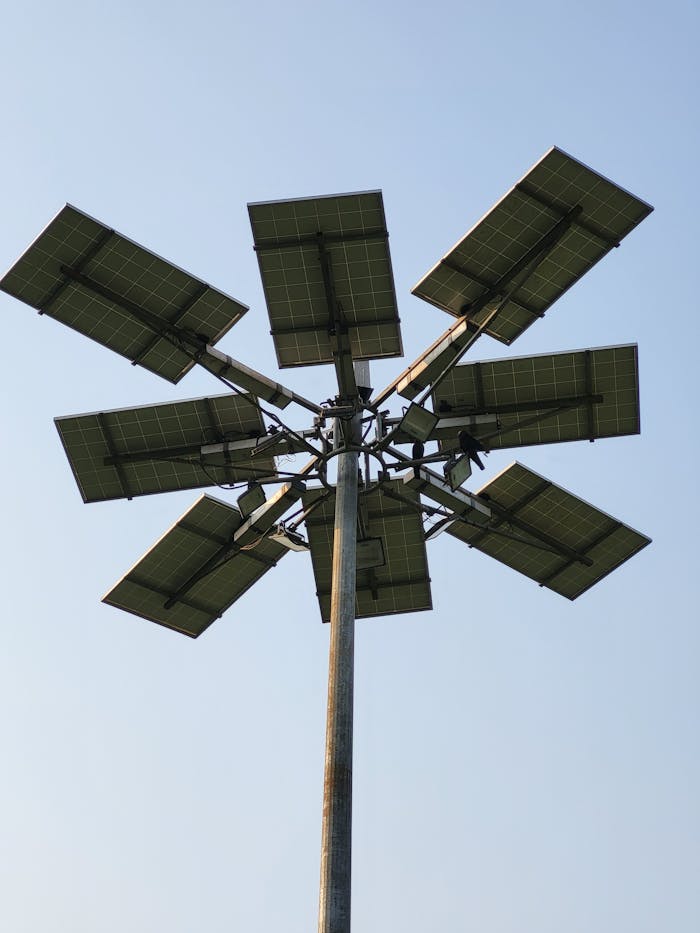 Close-up of a solar panel array against a blue sky, highlighting renewable energy.